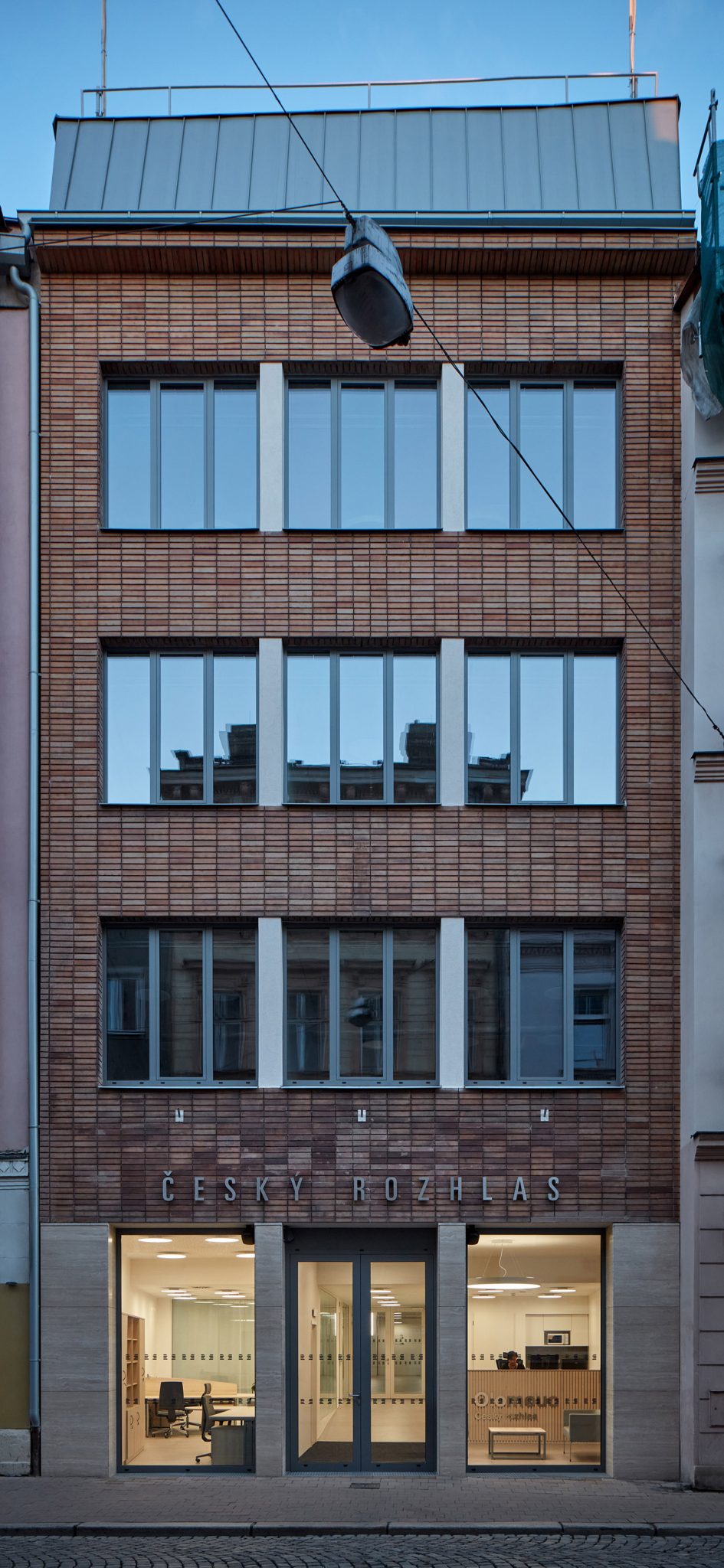 Photograph showing narrow facade of building onto street