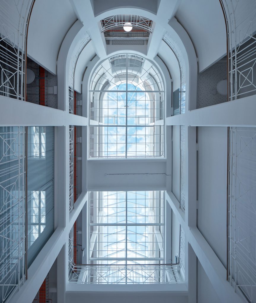 Photograph showing coolly-lit atrium circulation space