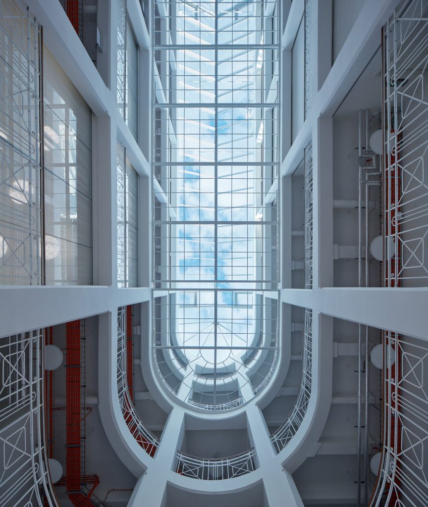 Photograph showing coolly-lit atrium circulation space