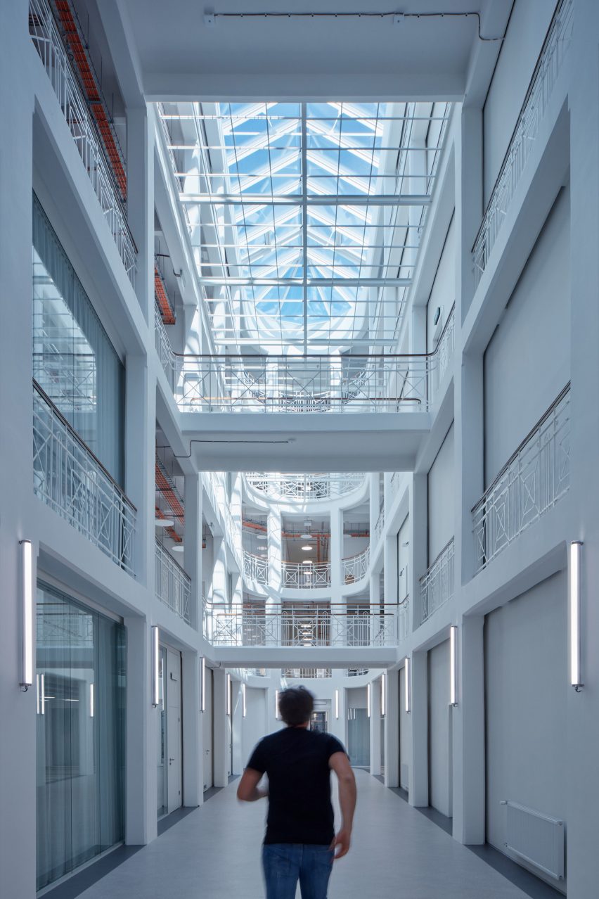 Photograph showing coolly-lit atrium circulation space