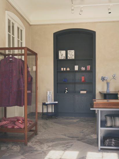 Goods on display in glass cabinet and built-in cabinets in museum shop