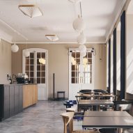 Tables, design chairs and stone floors at Designmuseum cafe
