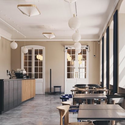 Tables, design chairs and stone floors at Designmuseum cafe