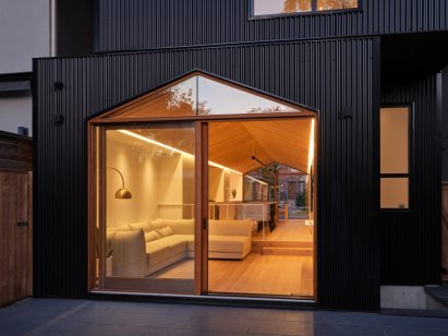 Corrugated metal facade of Toronto home with large sliding glass doors