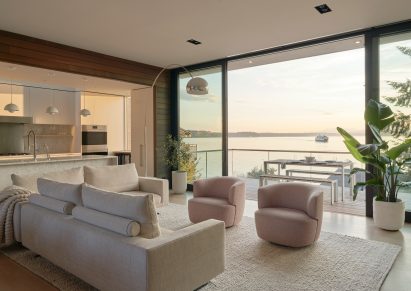 Living room and kitchen with large glass doors leading to balcony in Seattle home