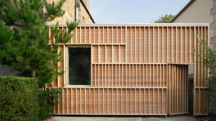 Photograph showing a timber-clad structure on the side of a house