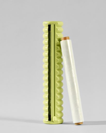 A roll of cling film next to a green dispenser