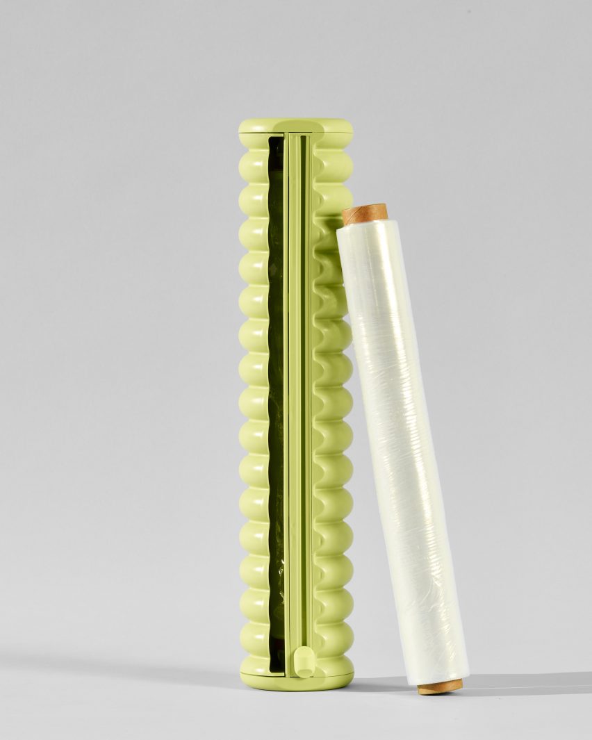 A roll of cling film next to a green dispenser