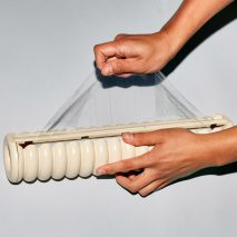 Two hands using Great Wrap cling film