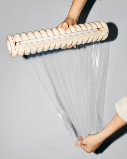 Two hands using Great Wrap cling film
