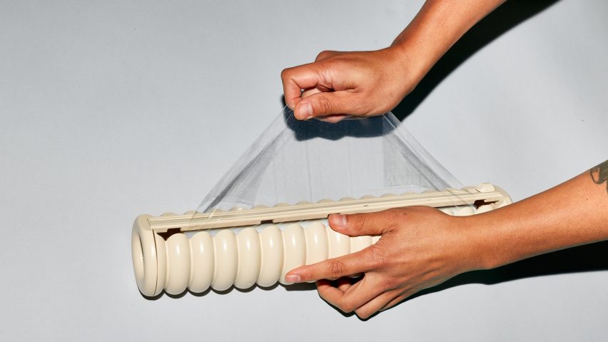 Two hands pulling Great Wrap cling film