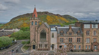 Exterior shot of church complex with Scottish countryside