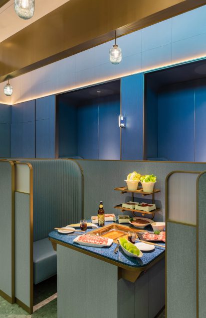 Shenzhen's Haidilao restaurant by Vermilion Zhou Design Group features blue-green interiors