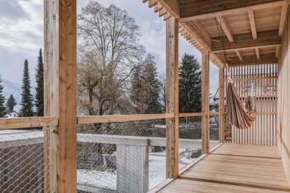 Timber balcony overlooking courtyard of Austrian alpine house