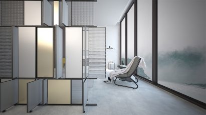 Interior of a grey living space with a lounge chair and wall separator by student at Istituto Marangoni