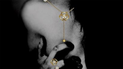 Black and white photograph of someone wearing a necklace and rings jewellery design by student at Istituto Marangoni