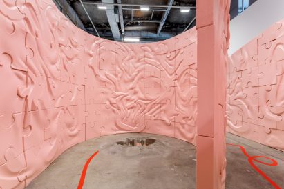 Curving pink labyrinth walls patterned with ridges