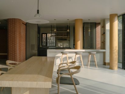 Open plan kitchen and dining area at Anna Garden House by Kiki Archi