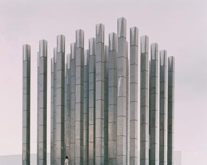 Person looking up at Less Pavilion by Pezo von Ellrichshausen