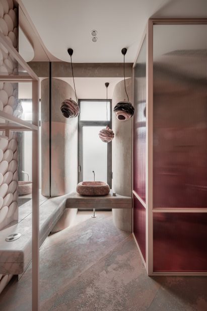Pink-toned bathroom of Mureli House with scale-like tiles