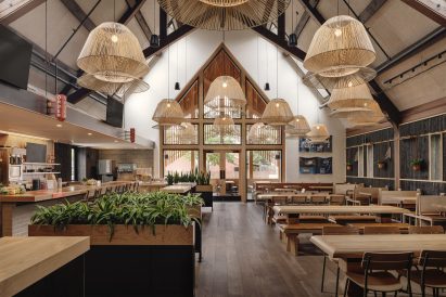 Loro Heights restaurant tables under hanging lights and exposed trusses