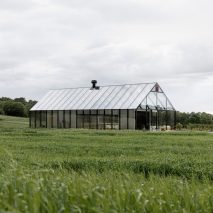 Norm Architects creates inside-out greenhouse restaurant in a Swedish meadow