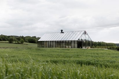 Glasshouse-like restaurant in Swedish meadow in vineyard