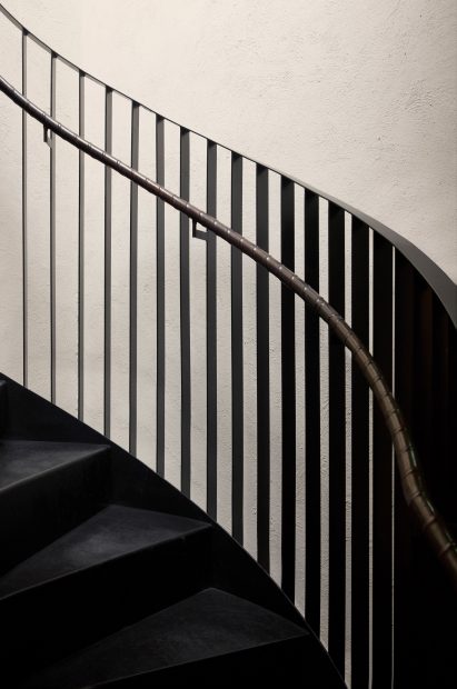 Sweeping black metal staircase of Tysta Mari restaurant