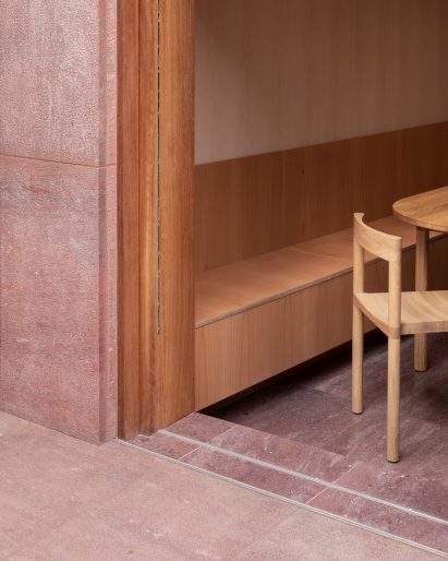 Detail image of Kensington Place's red stone cladding and wooden carpentry