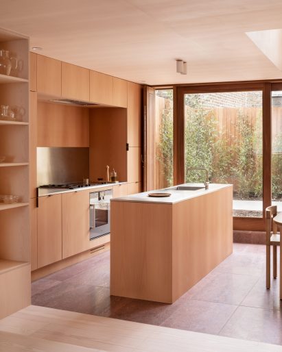 Kitchen by O’Sullivan Skoufoglou Architects lined with pale plywood
