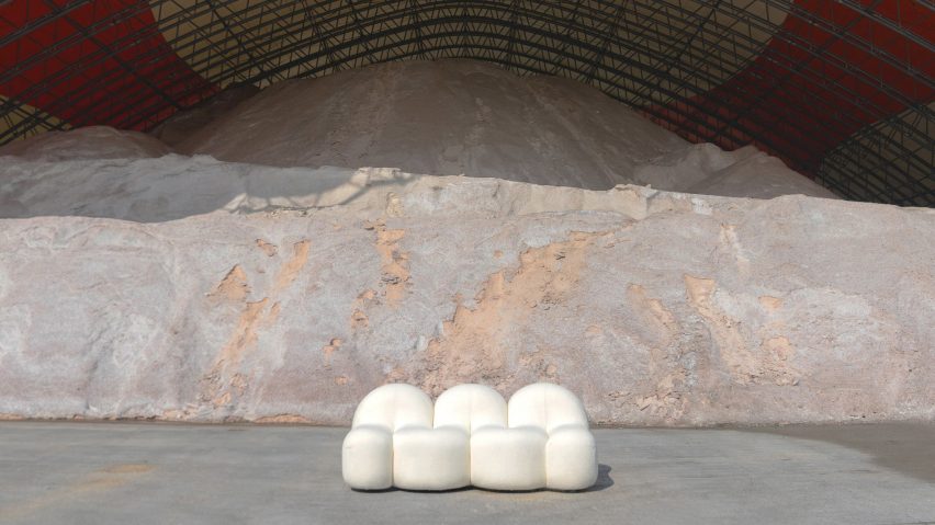Photograph of white rounded sofa in storage warehouse