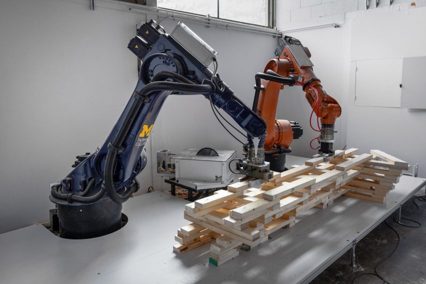 Two robotic arms assembling components