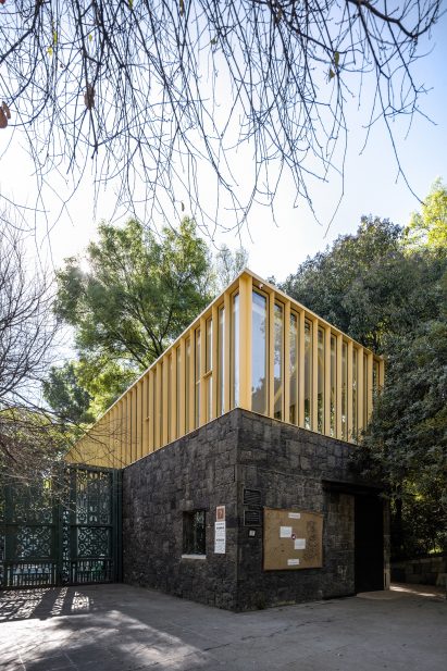 Yellow steel structure on top of stone building