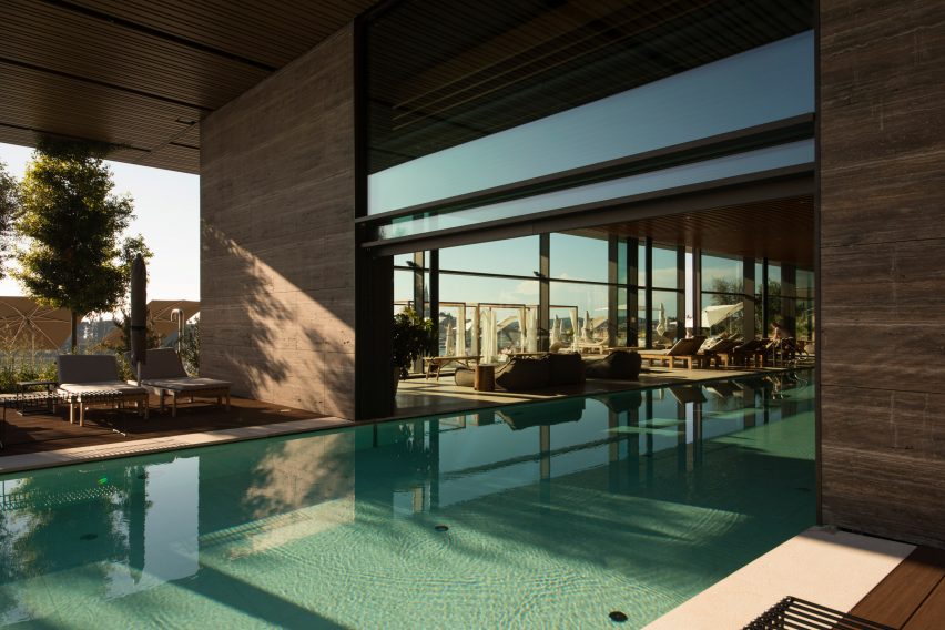 Vitrosca Guillotine glazing system over a luxury hotel pool