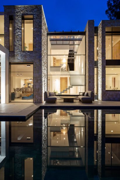 Vitrocsa Guillotine and Sliding window systems in a villa by a pool