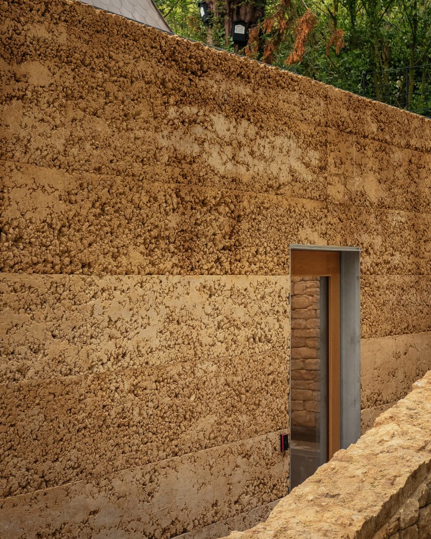 Rammed-earth exterior of Invisible Studio's yoga studio at The Newt in Somerset