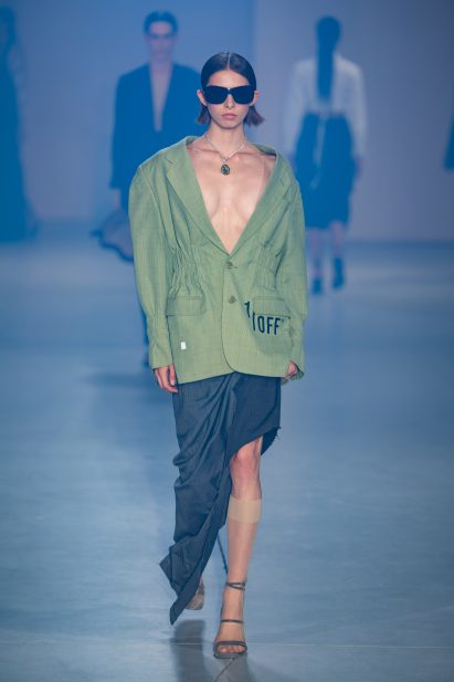 A model is pictured wearing suiting that has been re-tailored 