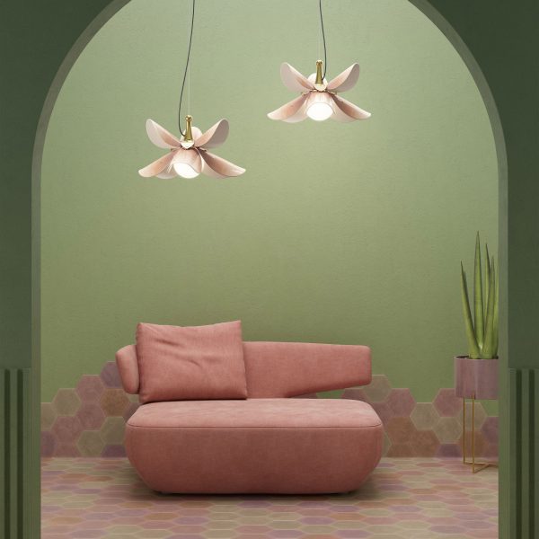Photo of a pink sofa in a green room with pink overhead lights