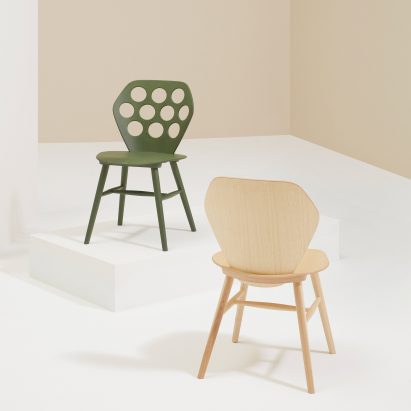 Photograph showing two chairs on plinths on white background