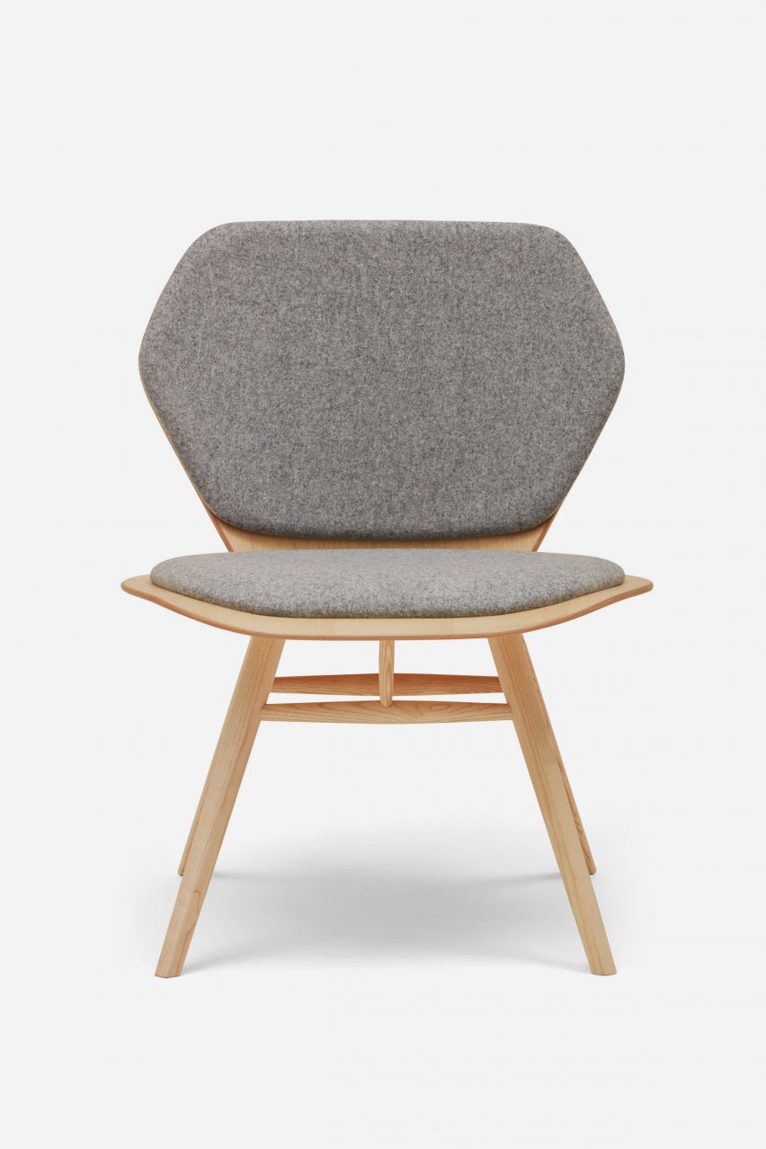 Photograph of grey upholstered chair on white backdrop