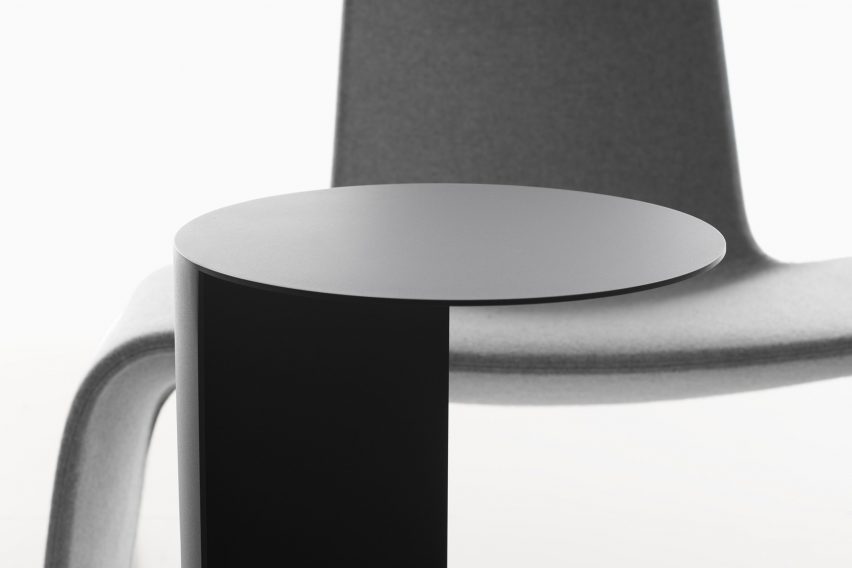 Photograph showing detail of side table top with lounge chair behind