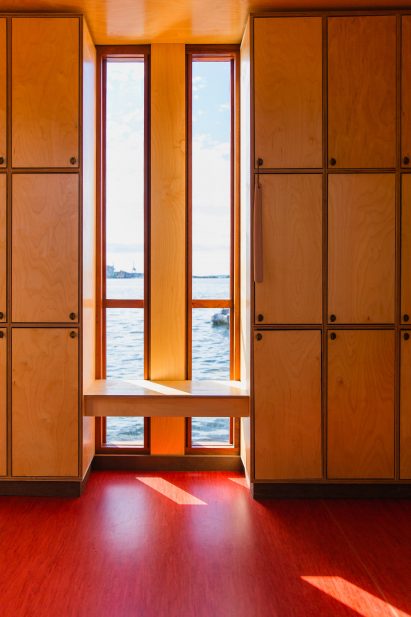 Sauna locker room in Bademaschinen by ACT! Studio and Borhaven Arkitekter with tall slim windows and doorknobs of reclaimed brass