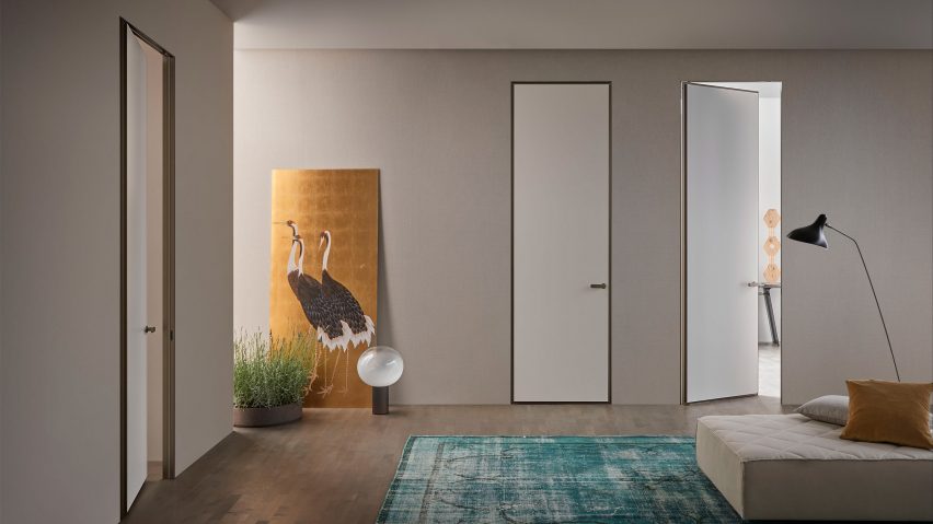 Three white-painted doors in a living-hall space with seating and floor lamp