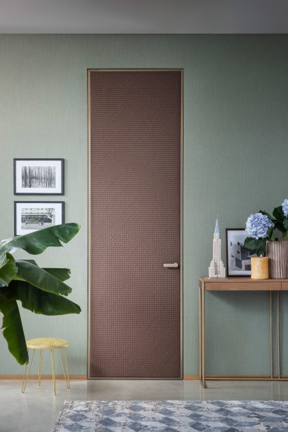 Woven leather door by Lualdi in a teal painted room
