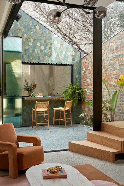 Blue and green tiles on wall of courtyard in Australian house