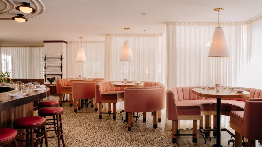 Table seating beside Bar Enza's zigzagging windows