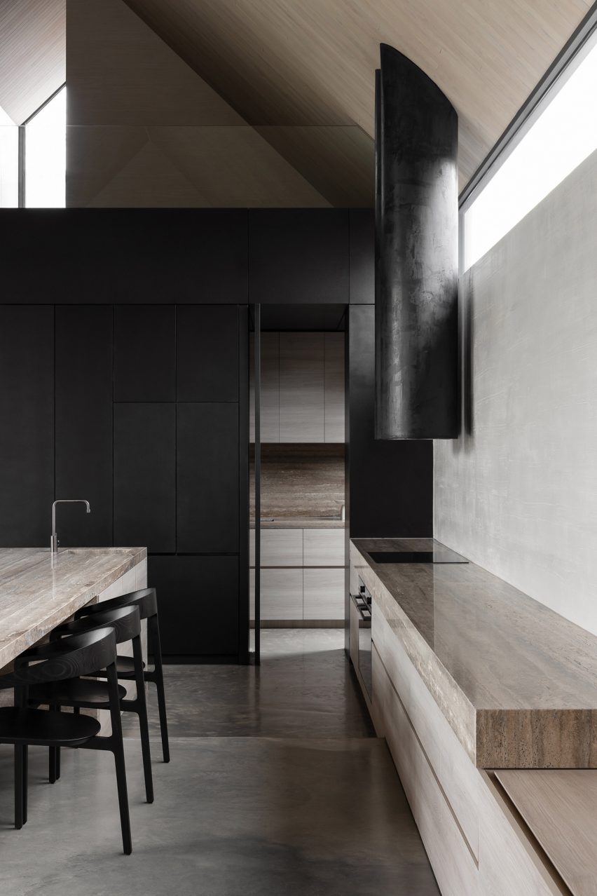 Material and spatial contrasts define coastal cottage extension by Adam Kane Architects