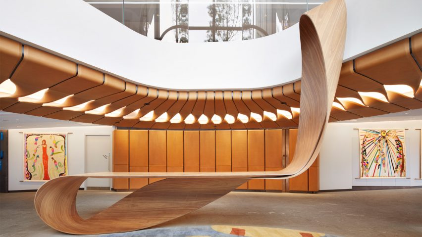 Bent timber desk in circular lobby of 22 Bishopsgate by Bill Amberg Studio
