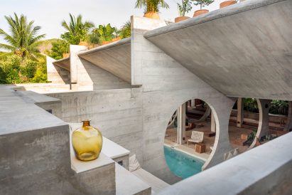 An aerial view of a hotel pool in a courtyard