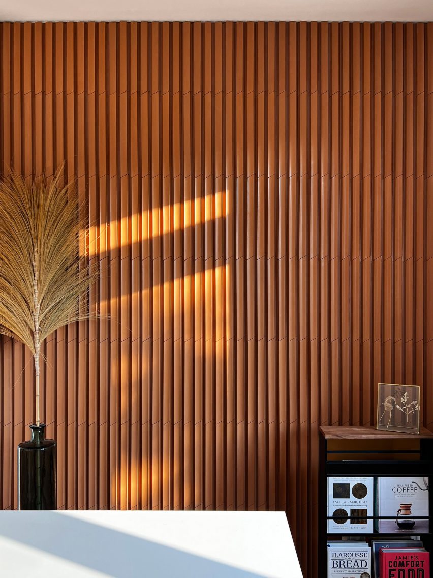 Terracotta fluted Earth Tone tiles used on a wall with natural light falling on it